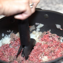 Load image into Gallery viewer, dbChopper kitchen gadget chopping ground beef and diced onions as it browns in a metal skillet