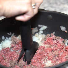 Load image into Gallery viewer, dbChopper kitchen gadget chopping ground beef and diced onions as it browns in a metal skillet
