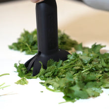 Load image into Gallery viewer, dbChopper in use chopping fresh herbs like cilantro and parsley on a clean counter
